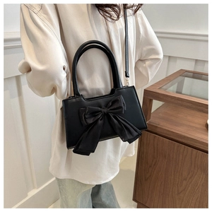 Chic black PU leather handbag with a large silk-texture bow decoration on the front