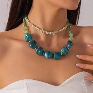 Detail of double-layer acrylic necklace with green irregular geometric resin stones