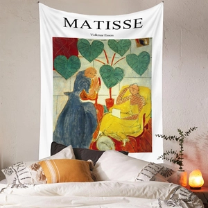 Detailed close-up of Matisse art tapestry hanging over a bed with warm lamp lighting