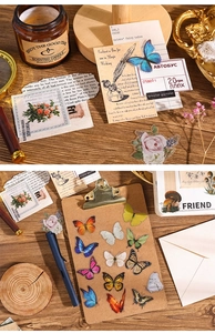 Detailed view of vintage botanical stickers with butterfly and floral motifs on wood