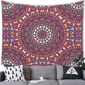 Detailed view of bohemian mandala tapestry hanging on wall above a sofa in living room