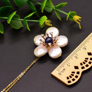Baroque pearl flower pendant necklace with blue center bead and gold chain