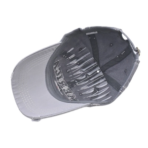 Internal view of a washed grey baseball cap showing embroidery and a plastic hat shaper