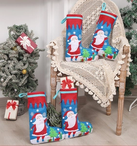 Set of four blue Christmas stockings with Santa and tree motifs for holiday gift decor