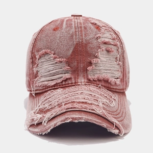 Macro detail showing the vintage washed fabric and distressed ripped edges of this baseball cap