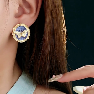 Vintage gold butterfly stud earrings with blue enamel in a retro french palace style