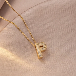 Detailed macro view of a gold-plated letter P pendant with sparkling cubic zirconia inlay
