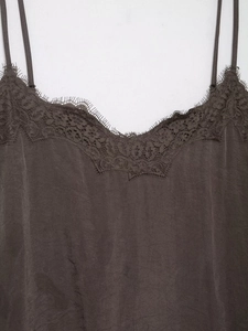 Detailed close-up of dark charcoal lace trim silk camisole top with v-neckline