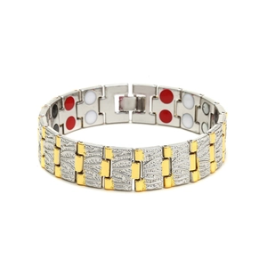 Detail view of the silver and gold magnetic therapy bracelet showing textured dragon pattern