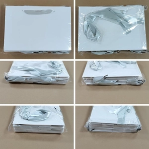 Bulk set of premium white paper gift bags with grey ribbon handles in clear packaging