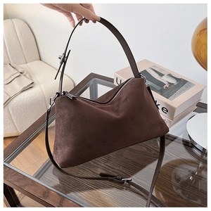 Detailed view of the dark brown suede hobo bag with adjustable leather strap and silver buckle