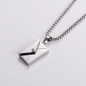Detailed view of silver envelope pendant necklace with sparkling cubic zirconia stone