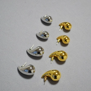 Detail of hollow waterdrop stud earrings in gold and silver showing size variety