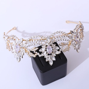 Close-up of gold bridal tiara with marquise-cut crystals and floral rhinestone patterns