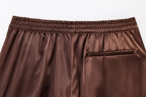 Detail view of coffee satin shorts featuring elastic waistband and rear pocket design