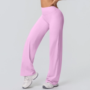 Detail of high-waisted pale pink wide-leg yoga pants showing soft elastic fabric texture