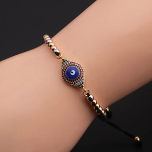 Detail of adjustable evil eye bracelet with tri-color gold beads and zircon pendant