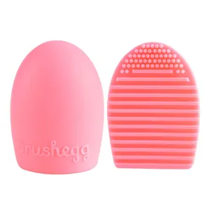Pink silicone brush egg cleanser tool featuring textured scrubbing surface and smooth back