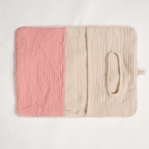 Detail of pink and beige muslin cotton nursery organizer bag with soft texture