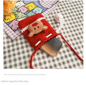 Detail of red crochet reindeer bag showing internal space for a smartphone storage