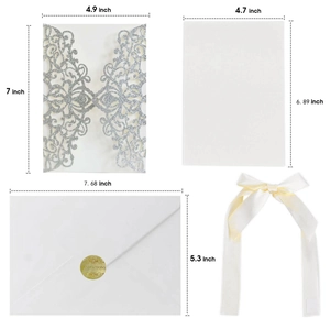 Detailed view of laser-cut silver glitter invitation suite with ribbon and dimension tags