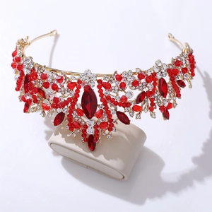 Detailed view of handmade bridal crown with red crystals and gold leaf patterns