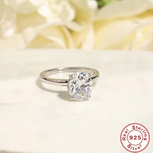S925 sterling silver engagement ring with oval-cut cubic zirconia on marble background