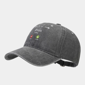 Détail de la broderie Jesus Calling sur une casquette en coton délavé gris foncé