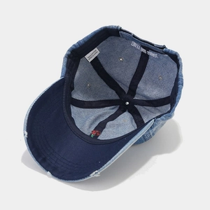 Distressed navy denim baseball cap with rose embroidery and washed cotton finish