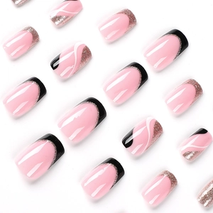 Pink press-on nails with black French tips, rose gold glitter, and white wavy lines