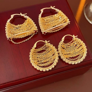 Macro shot of gold plated geometric chain earrings with sparkling cubic zirconia accents
