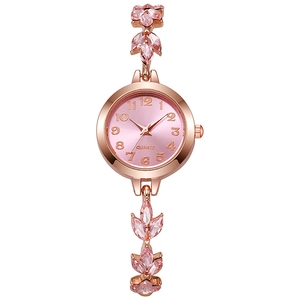 Macro detail of clover leaf bracelet watch band with pink crystals and rose gold finish