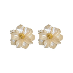 Elegant white camellia resin flower earrings with gold bead center on white background