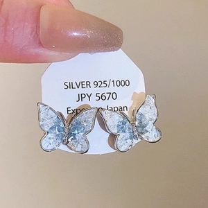 Detail of blue gradient butterfly earrings with cracked ice effect and silver needles