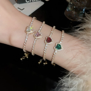 Macro detail of adjustable heart tennis bracelets with colorful crystals on model wrist
