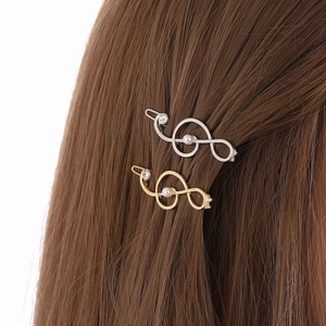Elegant gold and silver music note hair clips with pearls and rhinestones on hair
