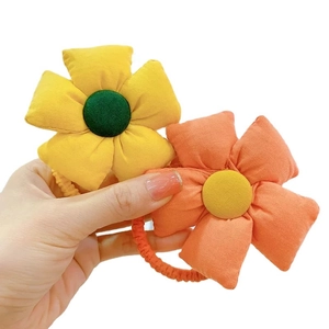 Cute fabric flower hair ties for girls featuring yellow and orange floral designs
