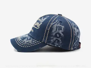 Detail view of washed denim vintage baseball cap with side printing and 3D embroidery