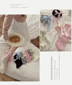 Detailed cable-knit texture on socks featuring large satin bows in multiple colors