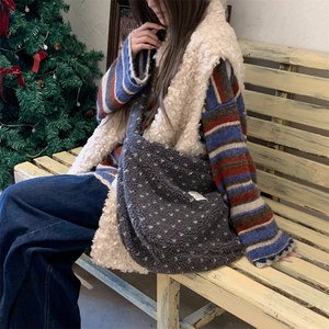 Deep grey plush tote bag styled with a winter knit outfit next to a Christmas tree