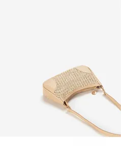 Detail of woven texture and smooth leather trim on a beige shoulder underarm bag