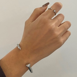 Silver stainless steel nail bracelet and ring set with crystals on a woman's hand