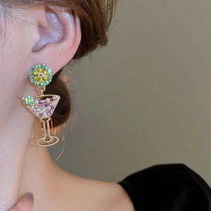 Detailed shot of creative cocktail glass earrings with lime slice and vibrant rhinestones