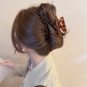 Detail of a large leopard print tortoiseshell claw clip for an elegant bun hairstyle