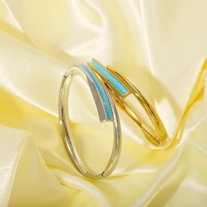 Minimalist stainless steel cuff bracelets with colorful enamel inlays on silk background