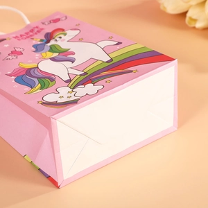 Pink unicorn gift bag with rainbow design and Happy Forever text for kids