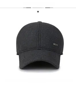Close-up of winter wool baseball cap featuring sport metal badge and double-stitched brim