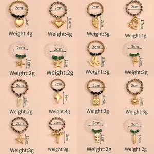 Grid of 16 elastic beaded rings with various gold metal charms and colorful bead details