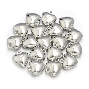 Close-up of heart-shaped silver metallic pendants with reflective faceted surface