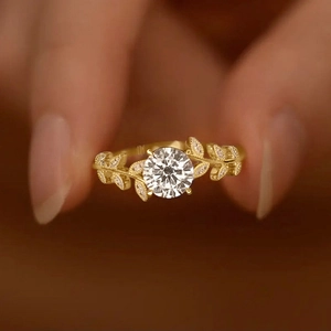 Laurel branch ring with leaf-shaped band and sparkling moissanite flower design